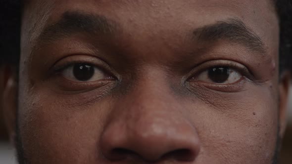 Extreme Closeup of a Surprised Africanamerican Man's Eyes Open an Raise the Eyebows