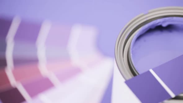 Close up of metal paint can with purple paint and paint swatch.