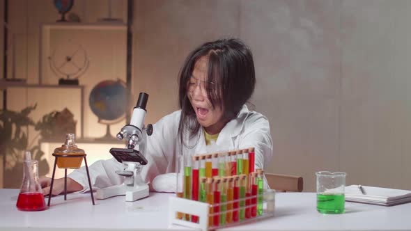 Excited Young Asian Scientist Girl With Dirty Face Looking At Microscope And Say Wow