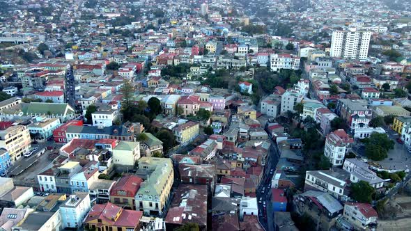 Aerial parallax of Valparaiso colorful houses in Cerro Alegre and Concepcion, cars driving in Urriol