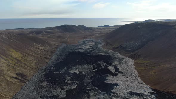 Lava from erupting volcano approaching the ocean, Iceland