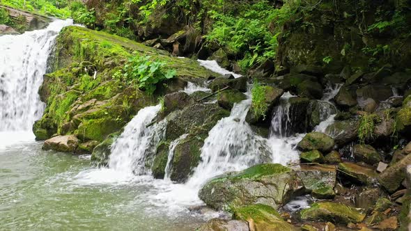 Mountain River Waterfall Flowing Between Rocky Shores in Carpathians Mountains Ukraine