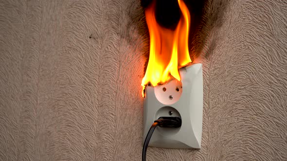 Burning Electrical Outlet on the Wall in the Room