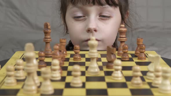 Little Girl in Isolation By Chess Board