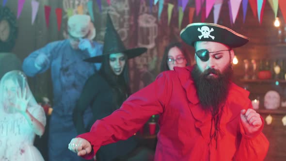 Handsome Man Dressed As a Pirate Is Dancing at a Halloween Party