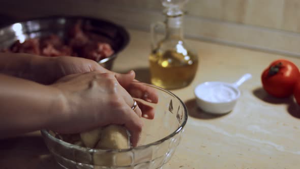 Closeup Female Hand Kneads Dough for Ravioli