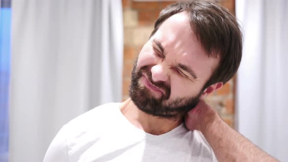 Beard Man with Serious Neck Pain Indoor