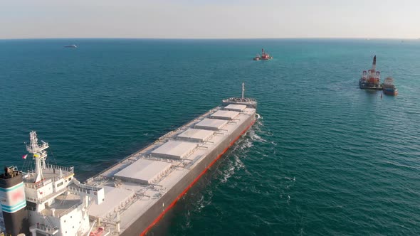 The Bulk Carrier Left the Port and Moves in the Right Direction at High Speed.