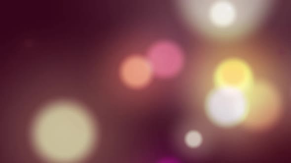 Animation of multi coloured glowing spots of light moving in hypnotic motion on background alt