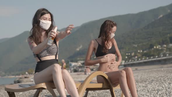 Young Attractive Girls Enjoying Beach Holidays in Bikini in Protection From Virus Infection