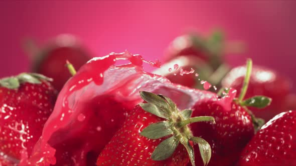 Slow Motion Shot of Strawberry Juice Splashing Through Strawberries