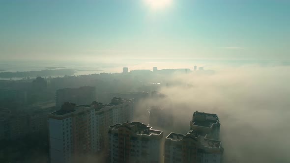 Aerial Drone Footage of Flying Over the City in Fog During Dawn