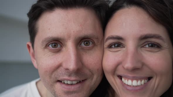 Happy Married Couple Closeup Looks at the Camera and Smiles