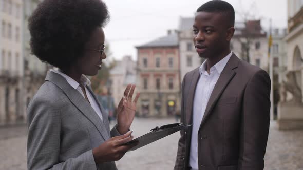 African Business Colleagues Standing on Street and Talking