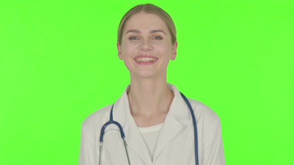 Smiling Female Doctor on Green Background