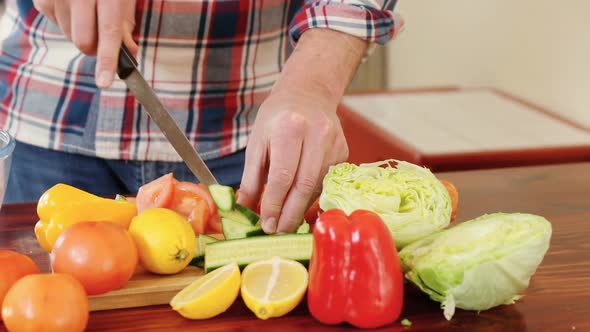 Man cutting vegetables in kitchen at home 