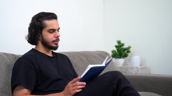 Indian man calmly reading a book