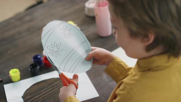 Boy Making Easter Card in Form of Egg