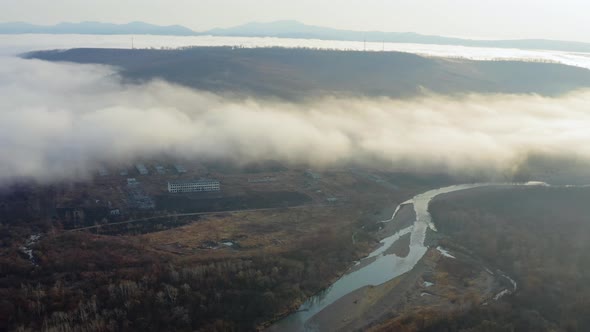 Flight Over the Valley Covered with Morning Mist in the Countryside