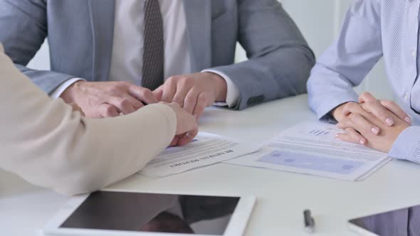 Close up of Hands of Business People Discussing Reports