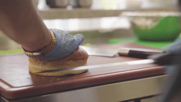 Close Shot a Knife Cuts a Fresh Bun