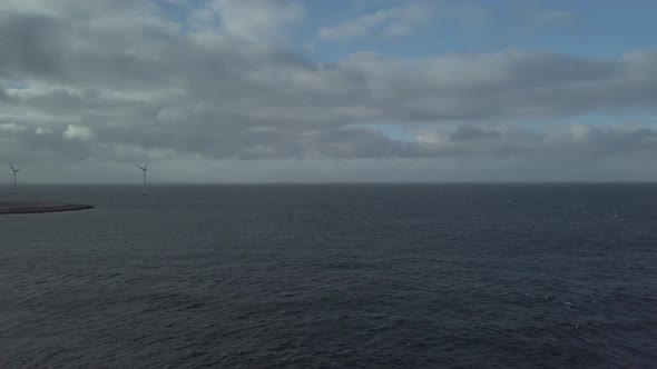 Looking out over the sea towards off shore windmills in Scandinavia