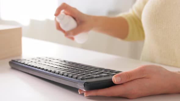 Close Up of Woman Cleaning Keyboard with Sanitizer