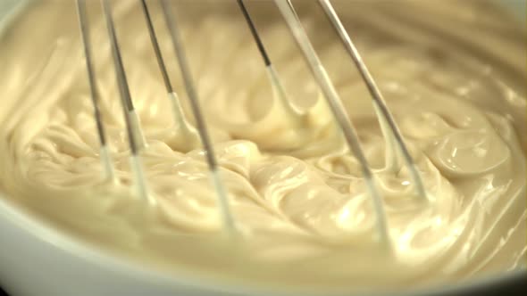 Super Slow Motion Homemade Mayonnaise Stirred with a Whisk in the Bowl