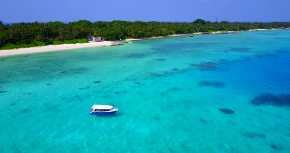 Beautiful birds eye travel shot of a white paradise beach and blue sea background in high resolution