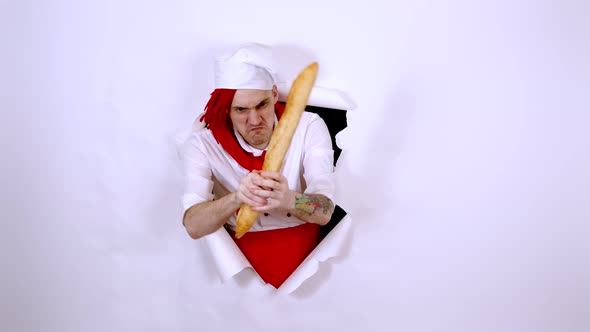 Young Man Dressed As Chef Holding White Bread As Sword