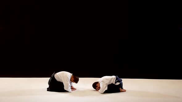 Two Masters Martial Arts Aikido Bow To Each Other. Shot Isolated on Black and White Background. Slow