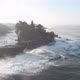 Aerial view over the water overlooking a Temple. The waves beat against the rocks and stones. - VideoHive Item for Sale