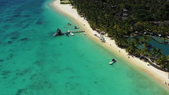 Beach along the waterfront and coral reef and palm trees, Mauritius, Africa, Pier near the beach of