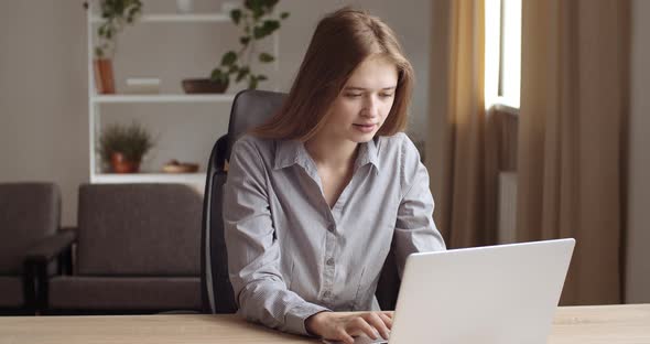 Portrait of Young Business Woman Student Looking at Laptop Screen Gets Good News Reads Positive