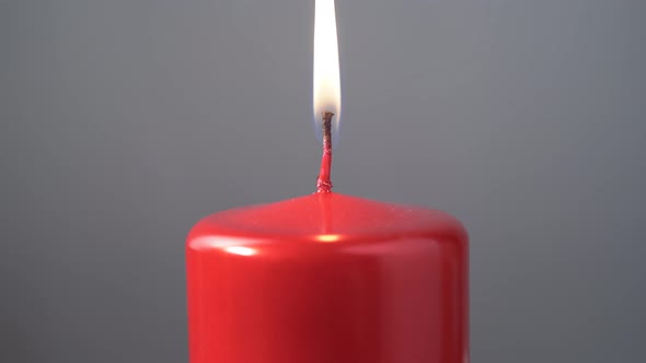 Caucasian Man Lighting up a Red Candle