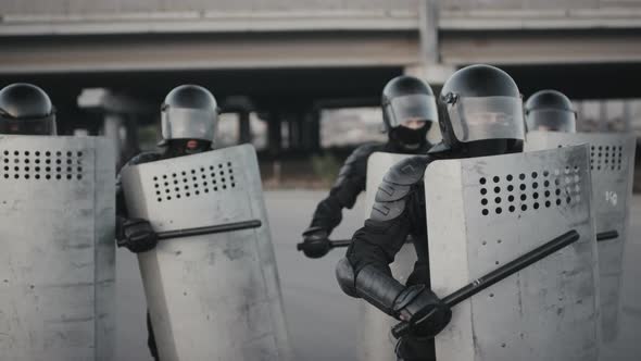 Riot Police Beating Shields with Batons