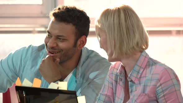 Black Man and Caucasian Lady Laughing and Smiling.