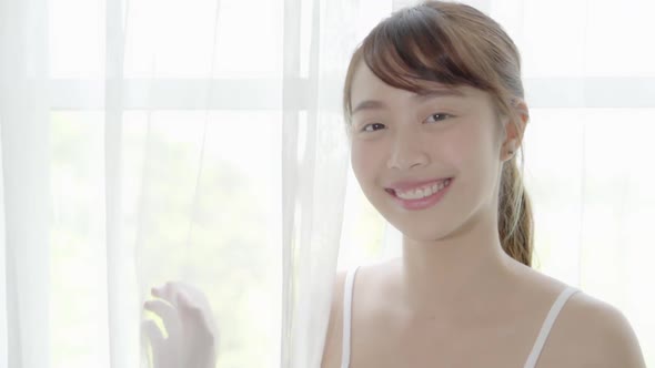 Beautiful closeup young asian woman with smiling and laughing in bedroom.