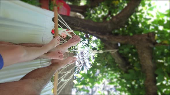 Father and Son Relaxing on Hammock in a Luxury Resort