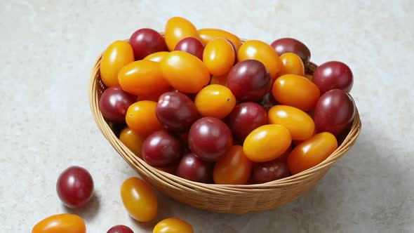 Basket with colorful cherry tomatoes close up