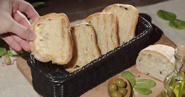 Put Fresh Toasters In A Basket On A Table Decorated With A Bouquet Of Flowers