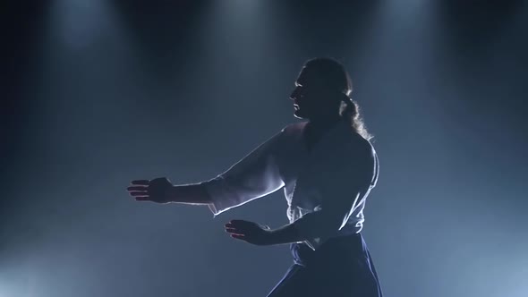 Fight Between Two Aikido Fighters in Dark Studio with Smoke and Lighting. Slow Motion. Close Up.