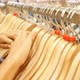 Female Hands Running on Clothing Hangers Rail Rack and Looking for Dress in Clothes Store - VideoHive Item for Sale