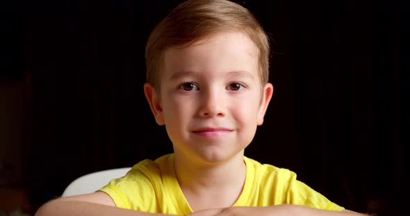 Portrait Funny Little Boy Smiling Child Looking at Camera are Sitting on the Black Background Cute