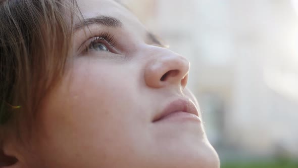 Close Up Face of Young Woman Enjoying Nature Dreaming Praying Looking Up