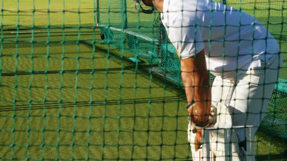 Cricket players practicing in the nets during a practice session