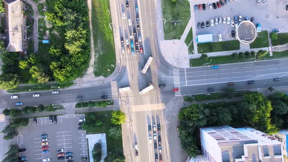 City traffic street crossroad in the rays of the setting sun. Drone footage
