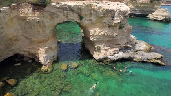 4K aerial of the rock formations of Sant'Andrea near Torre Dell'Orso, Apulia, Italy in the summer.