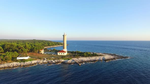 Flying over lighthouse, Croatia at sunset