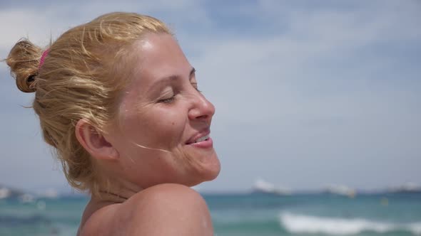 Caucasian female enjoys  French coast sun slow motion 1920X1080 HD video - Blonde  woman on the beac